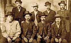 The "Dodge City Peace Commission" on June 10, 1883. From left to right, standing: William H. Harris, Luke Short, Bat Masterson, William F. Petillon; seated: Charlie Bassett, Wyatt Earp, Michael Francis "Frank" McLean, Cornelius "Neil" Brown.
