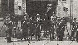A group of cameramen who worked for the Canadian Government Motion Picture Bureau in 1925. Frank Badgley, the bureau's director from 1927 to 1941, is in the background.