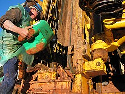 Driller pouring anti-foaming agent down the drilling string on a drilling rig