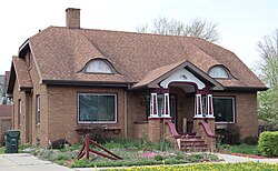 Brown brick bungalow with roof windows in Reedsburg, Wisconsin, U.S.