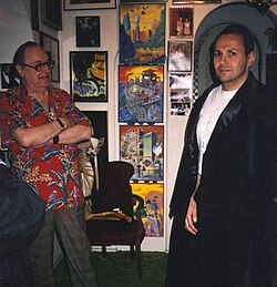 Letting a fan try on the cape worn by Bela Lugosi in Plan 9 from Outer Space (1957, directed by Ed Wood)