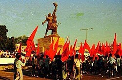 People celebrating the 14th October Revolution next to the Freedom Statue