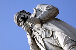 The statue of Spallanzani in Scandiano has him examining a frog through a magnifying glass.