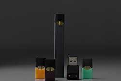 A JUUL brand nicotine aerosolizer or vaporizer ("vape"), produced in the common electronic cigarette (e-cigarette) style. Vapes and e-cigarettes are examples of nicotine-only products.