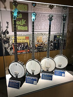 Four long-neck banjos inspired by Seeger's. The instrument on far left was closely constructed to match Seeger's. American Banjo Museum.