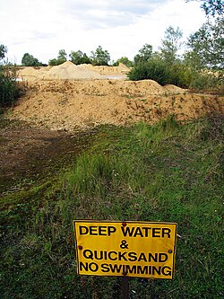 Quicksand and a warning sign about it at a gravel quarry in England