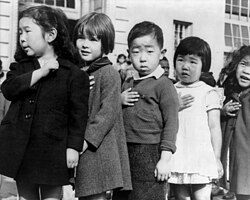 Children at the Weill public school in San Francisco recite the Pledge of Allegiance to the American flag in April 1942, prior to the internment of Japanese Americans.