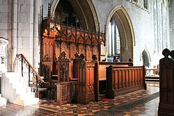 The stalls of St. Canice's Cathedral, Kilkenny, Ireland, showing the bishop's throne and precentor's stall.