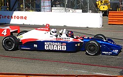 Howser riding in a tandem INDYCAR race car at the 2009 Long Beach Grand Prix