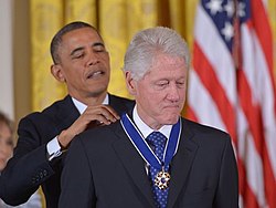 Clinton receiving the Presidential Medal of Freedom from Barack Obama, 2013