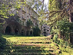 Abandoned concrete apartment buildings in a forested valley