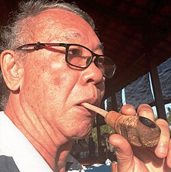Smoking a bamboo-bud pipe