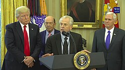 Director Peter Navarro addresses President Donald Trump's promises to American people, workers, and domestic manufacturers (Declaring American Economic Independence on June 28, 2016) in the Oval Office with Vice President Mike Pence and Secretary of Commerce Wilbur Ross before President Trump signs Executive Orders regarding trade in March 2017[338][339]