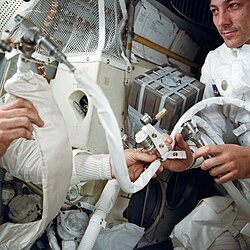 Swigert with the rig improvised to adapt the CM's lithium hydroxide canisters for use in the LM