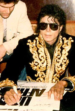 Jackson signing a "We Are the World" poster in 1985