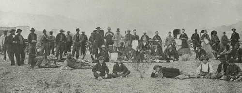 Young (seated near the middle, wearing a tall beaver hat) and an exploring party camped at the Colorado River in 1870