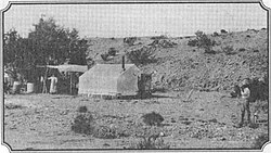 Wyatt Earp's camp, tent and ramada near Vidal, California and Wyatt's mining operations. Sadie is at left, Wyatt is on the right with his dog