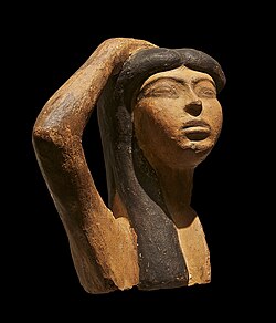 A rare sample of Egyptian terra cotta sculpture which may depict Isis mourning Osiris. The sculpture portrays a woman raising her right arm over her head, a typical gesture of mourning. Musée du Louvre, Paris.