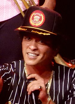 Two duets with Bruno Mars (pictured) rank within the top 10, with his Lady Gaga duet "Die with a Smile" coming in at number one, and his Rosé duet "APT." placing at number nine. The former made him the fourth act after the Beatles, George Michael and Elton John to top two Billboard Hot 100 Year-End lists, with his first being "Uptown Funk" in 2015.[1]