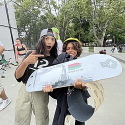 Skateboarders excited to receive a free skateboard deck as a prize at a skate contest, 2021