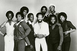Earth, Wind, & Fire c. 1977. Front, from left: Verdine White, Al McKay, Philip Bailey, Maurice White, Andrew Woolfolk, Ralph Johnson. Back, from left: Larry Dunn, Fred White, Johnny Graham.