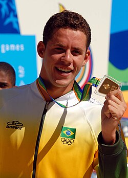 Swimmer Thiago Pereira of Brazil has a record 23 Pan American medals.[34] Here he holds a gold medal during the 2007 edition.