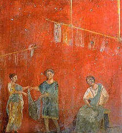 Women working alongside a man at a dye shop (fullonica), on a wall painting from Pompeii