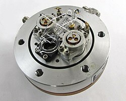 A force-balanced fused quartz Bourdon tube pressure sensor. The mirror that should be mounted to the armature is absent.