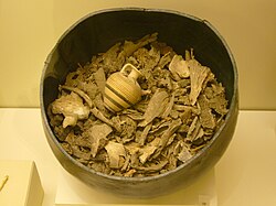 Bronze container of ancient cremated human remains, complete with votive offering