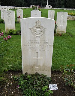 QR code tile next to the grave of Wing Commander Adrian Warburton at Durnbach War Cemetery in Gmund am Tegernsee, Germany. The code links to his Wikipedia entry.