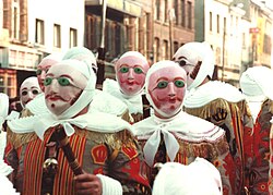 The Gilles of Binche, in costume, wearing wax masks