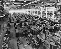 The assembly plant of the Bell Aircraft Corporation in 1944. Note parts of overhead crane at both sides of photo near top.