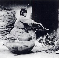 Kate T. Cory, Piki making, photograph, 1905–1912, Museum of Northern Arizona, Flagstaff. The image is representative of the personal nature of the composition – taken from the floor level, capturing light and shade and focused on everyday life.[1]