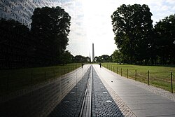 The Vietnam Veterans Memorial, a two-acre (8,100 m2) site featuring two black granite walls engraved with the names of those service members who died or remain missing in the Vietnam War designed by Maya Lin, was initially controversial for its lack of heroic iconography, a departure from earlier memorial designs.