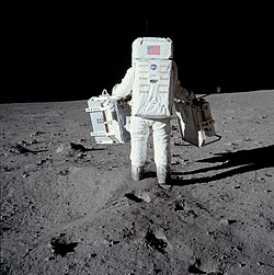 On Apollo 11, Buzz Aldrin simply carried the EASEP to the deployment site by using handles. This is different from the carrybar used on later missions.