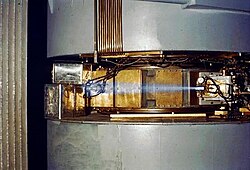 Ionized air glows blue around a beam of particulate ionizing radiation from a cyclotron