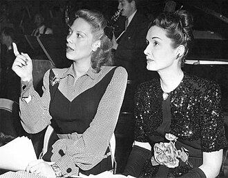 Shore (left) and Gail Patrick in the CBS Radio studio at a rehearsal for The Screen Guild Theater (1945)