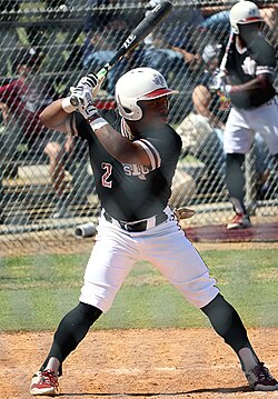 A Tigers baseball player batting in a game at MacGregor Park, March 2022