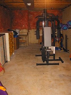 An unfinished basement used for storage and exercise