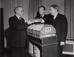 First Archivist of the United States R. D. W. Connor receiving the film Gone with the Wind from Senator Walter F. George of Georgia (on the left) and Loew's Eastern Division Manager Carter Barron, 1941