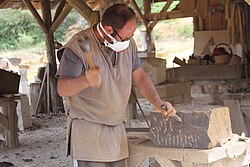Stonemason working with medieval tools