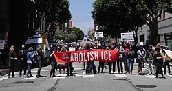 DSA members holding an "Abolish ICE" banner at a protest in San Francisco, 2018