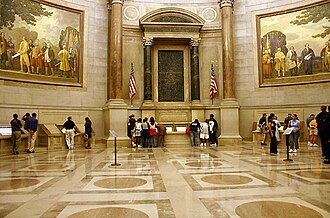 The National Archives' Rotunda for the Charters of Freedom where, in-between two Barry Faulkner murals, the original United States Declaration of Independence, United States Constitution, and other American founding documents are publicly exhibited