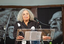 Davis speaks at a memorial for Miss Major Griffin-Gracy at Glide Memorial Church, December 2025.