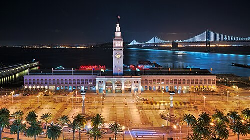 San Francisco Ferry Building, The Embarcadero, and the Bay Bridge at night, all examples of infrastructure