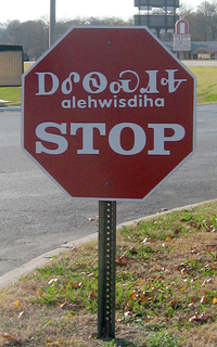 Cherokee stop sign with Cherokee language transliteration and the Cherokee syllabary in Tahlequah, Oklahoma, with "alehwisdiha" (also spelled "halehwisda") meaning "stop"