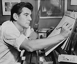 Bernstein at the piano, annotating a musical score, 1955
