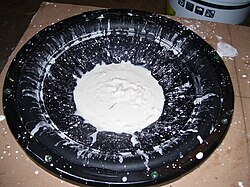 Oobleck on a subwoofer. Applying force to oobleck, by sound waves in this case, makes the non-Newtonian fluid thicken.[16]