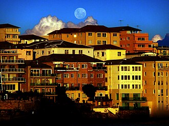Moon above low-rise apartments in Bondi, Australia