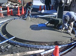 Pouring and smoothing out concrete at Palisades Park in Washington, DC